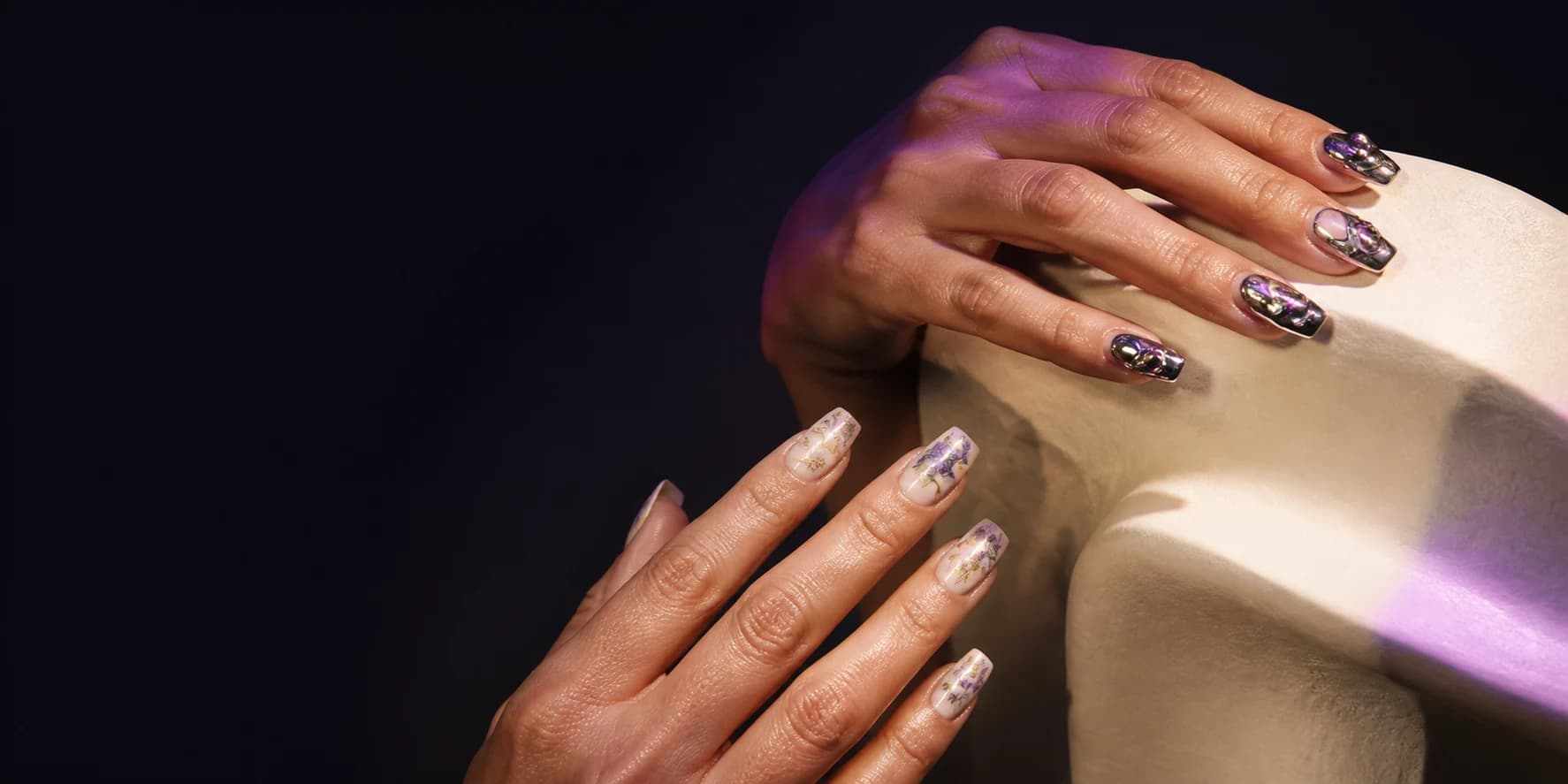 Two hands wearing distinctive handmade press-on nail art
