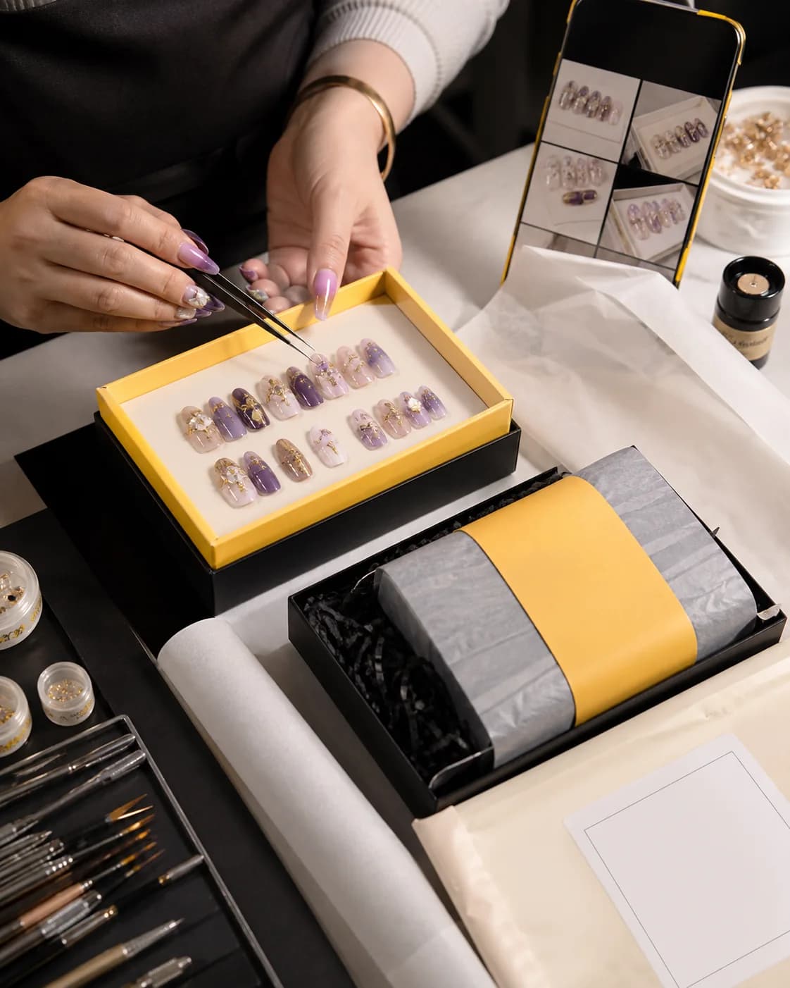An artist making the commissioned press-on nail set